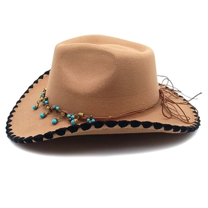 Detail of khaki cowboy hat with turquoise bead trim and black crochet edge band