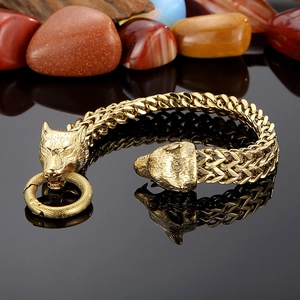 Close-up of golden wolf head clasp on franco link men's stainless steel bracelet