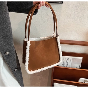 Close-up of vintage brown faux suede handbag with soft white fleece trim details
