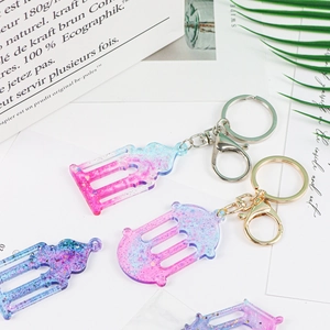 Macro detail of glitter acrylic mosque charms and gradient castle jewelry accessories