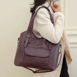 Large dark purple leather shoulder bag for women with adjustable strap and front pocket design