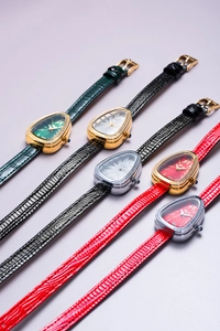 Macro shot of elegant snake-head quartz watches with leather straps and crystal bezels