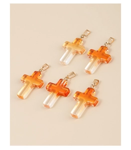 Detailed view of five orange gradient glass cross pendants with golden bails