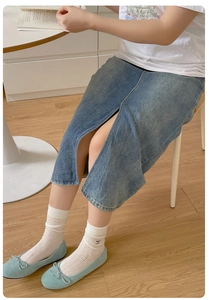 Close-up of white mesh socks with bow knot ballet flats and denim skirt outfit