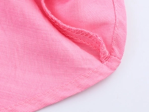 Macro shot of pink fabric texture and high-quality hem stitching on the summer dress