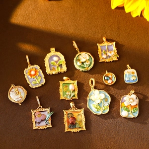 Detailed assortment of vintage floral enamel and baroque pearl pendants on fabric