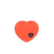 Detailed view of a red heart-shaped wireless key finder with a power button on white background