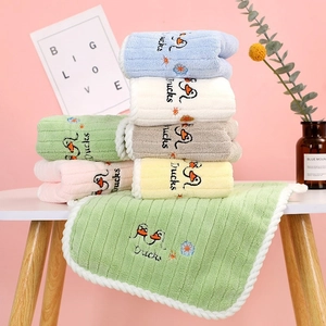 Close-up of soft coral fleece towels with duck embroidery and wavy edges in six pastel colors