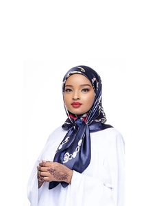 Detailed view of dark blue satin scarf with elegant golden chain pattern worn by a model