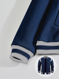 Detail of navy blue varsity jacket with grey striped ribbed cuffs and collar