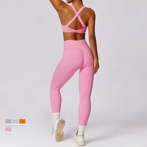 Women's pink yoga set featuring a backless sports bra and high-waisted leggings