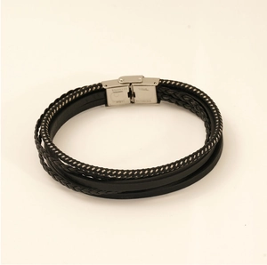 Detail of multi-layer braided leather bracelet with engraved stainless steel magnetic clasp
