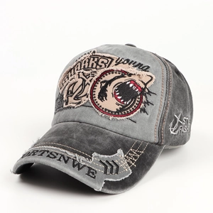 Detail of distressed dark grey baseball cap with shark embroidery and torn fabric edges