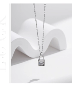 Macro shot of silver square lock pendant with a sparkling square cut moissanite stone