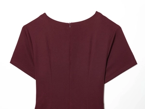 Detail of burgundy balloon sleeve dress featuring a discreet back invisible zipper closure