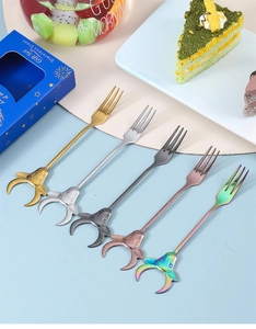 A set of five colorful stainless steel dessert forks with bull head decor in a gift box
