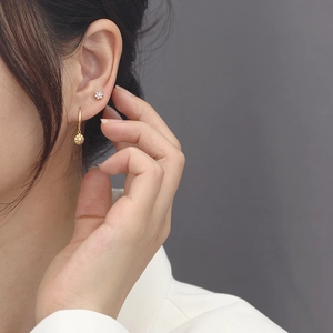 925 sterling silver gold floral earrings with sparkling cubic zirconia on a female model