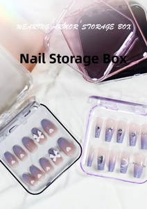 Stack of transparent pink and purple press-on nail storage boxes with decorative tips