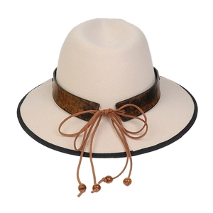 Close-up of cream wool fedora with brown leather band and beaded knot detailing