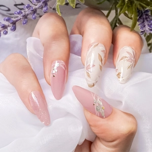 Pink and beige almond-shaped nail stickers with hand-painted floral patterns and glitter