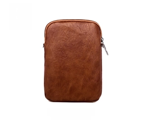 Detail view of the textured brown leather back on this vintage crossbody mobile phone bag
