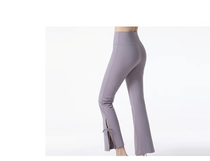 Detail of high-waist yoga flare pants showing side split leg with cute bow tie knot