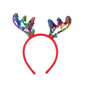Detail of red Christmas antler headband with colorful sequins and green leaf accents