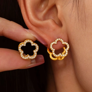 18K gold plated flower hoop earrings with white zircon accents shown on a model