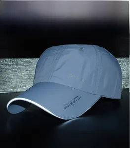 Detail of grey sports cap featuring high-visibility reflective brim and classic lettering