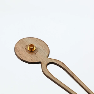 Natural walnut wood clock hands set with polished gold metal center eyelets