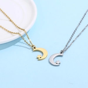 Close-up of moon and star pendants in gold and silver finish on necklaces