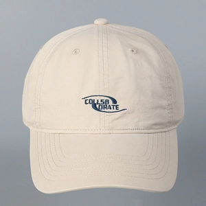 Close-up of COLLAB ORATE blue letter embroidery on beige washed cotton baseball cap