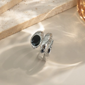 Snake wrap ring in silver steel with quilted texture and black enamel accent