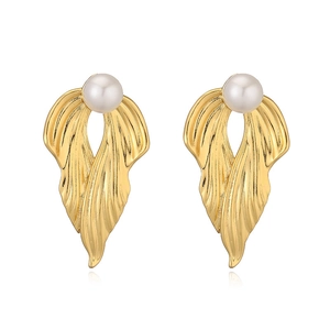 Elegant gold feather earrings with white pearls and textured finish on a white background