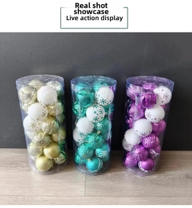 Detail of assorted Christmas ball ornaments in gold, green and purple within PVC packaging
