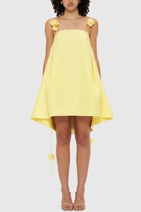 Close-up of vibrant yellow A-line mini dress featuring 3D floral accents on straps