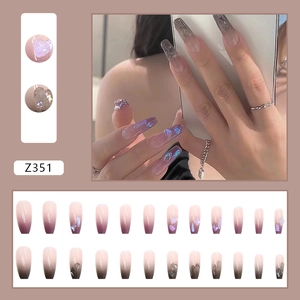 Detail view of long coffin press-on nails with purple gradient and heart glitter accents