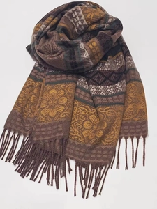Close-up of ethnic striped patterns and fringe tassels on a thick cashmere scarf