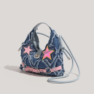 Y2K style blue denim crossbody bag featuring pink star patches and fringe trim detail