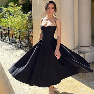 Detail of elegant black backless midi dress with waist slimming and full skirt design
