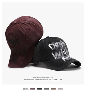 Detail view of washed cotton baseball caps with Don't Wake Me graffiti print