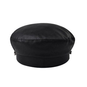 Close-up of black PU leather newsboy cap with fine texture and side metal button