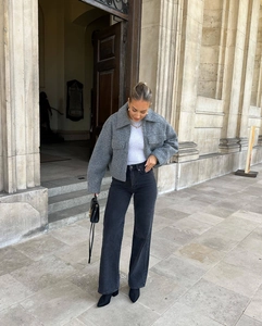 Street style shot of a grey short wool coat paired with high-waist wide-leg jeans