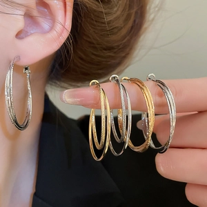 Detail of 18k gold plated double layer textured hoop earrings in gold silver rose gold