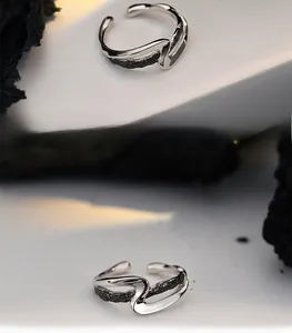 Detail showing wave-shaped S925 sterling silver ring with black lava rock texture inside