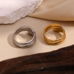 Macro detail of gold and silver snake head rings with white stones on texture