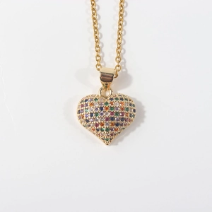 Macro shot of gold plated heart pendant with colorful zircon micro-pave setting detail