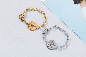 Detailed view of silver and gold tree of life bracelets with textured toggle clasps