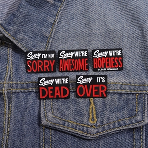 5pcs punk enamel pins set featuring black and red text phrases on denim jacket