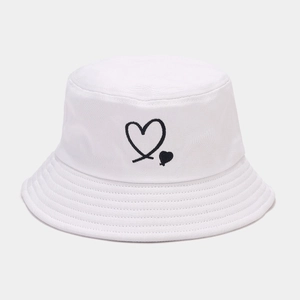 Detail of black heart embroidery and fine stitching on a white cotton bucket hat